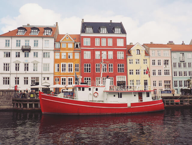 Colourful buildings and red boat in Nyhavn in Copenhagen