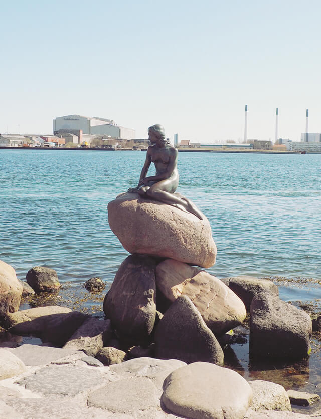 The Little Mermaid statue with sea behind in Copenhagen