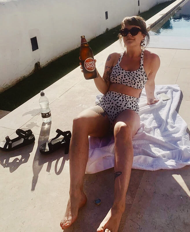 Lyzi Unwin drinking Super Bock beer at airbnb apartment Lisbon city guide travel blogger