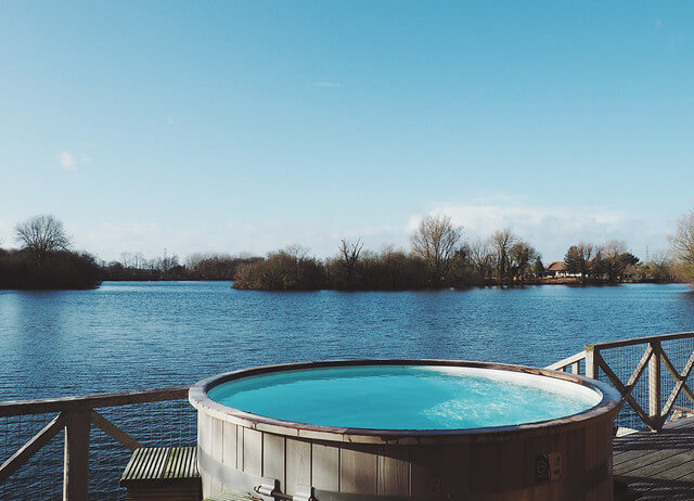 Hot tub at Log House Holidays lakeside cabin retreat in the Cotswolds