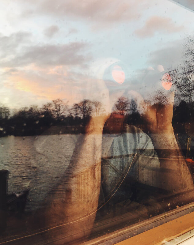 Window reflections at Log House Holidays lakeside cabin retreat in the Cotswolds