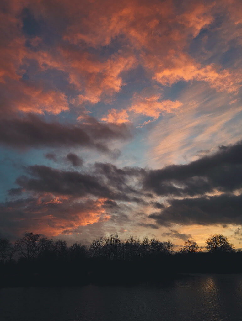 Sunset at Log House Holidays lakeside cabin retreat in the Cotswolds