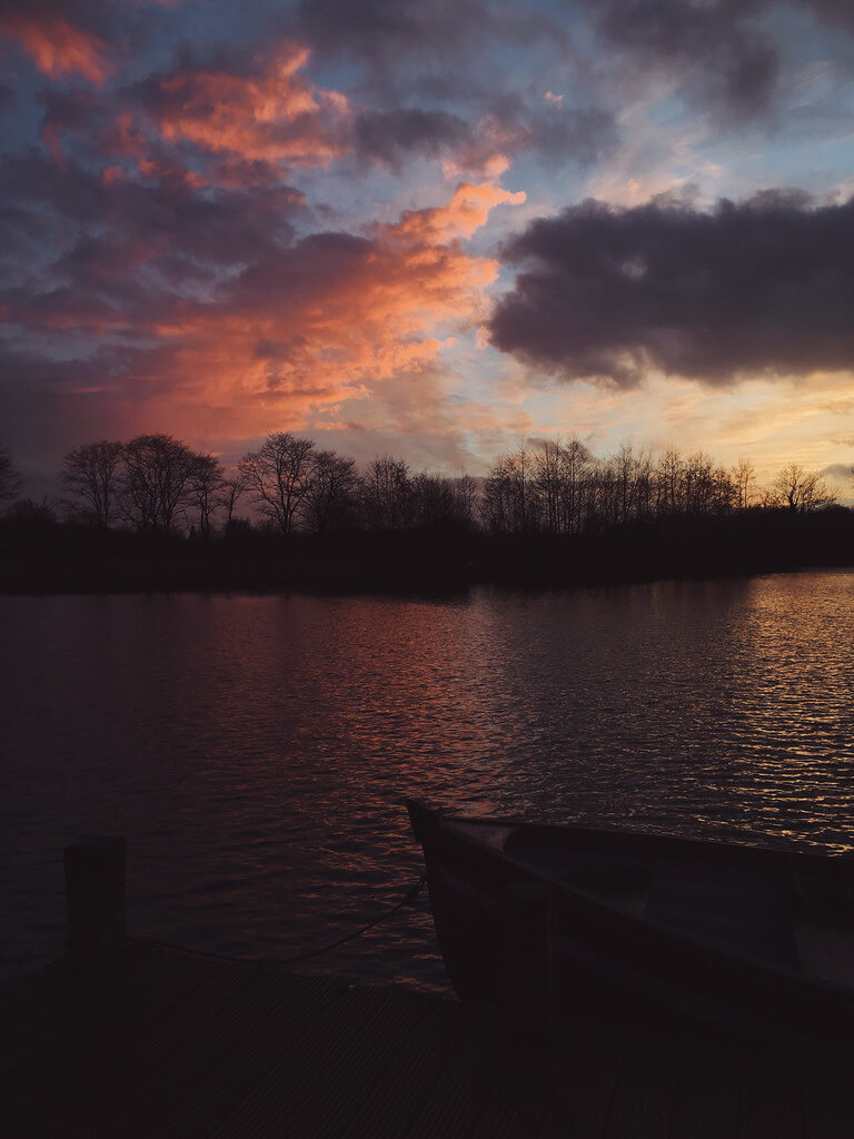 Sunset at Log House Holidays lakeside cabin retreat in the Cotswolds