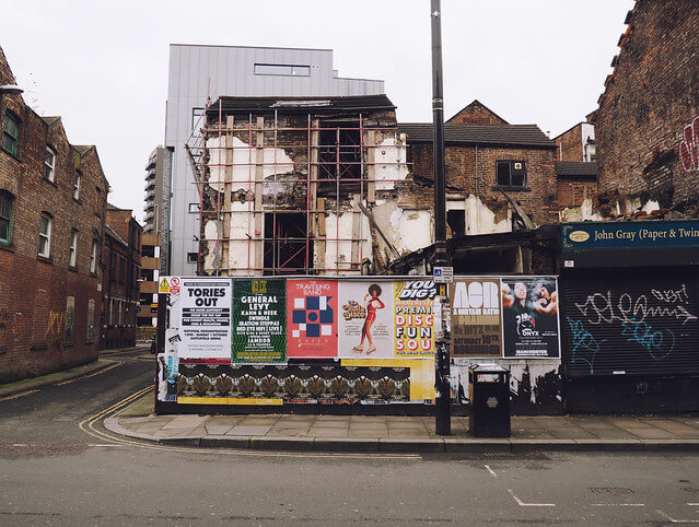 Manchester dilapidated brick buildings with posters