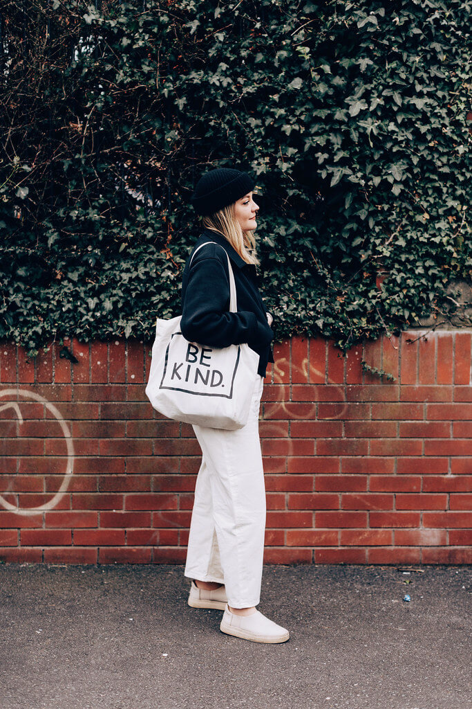 Lyzi Unwin wears monochrome outfit for early spring with be kind tote bag in Bristol