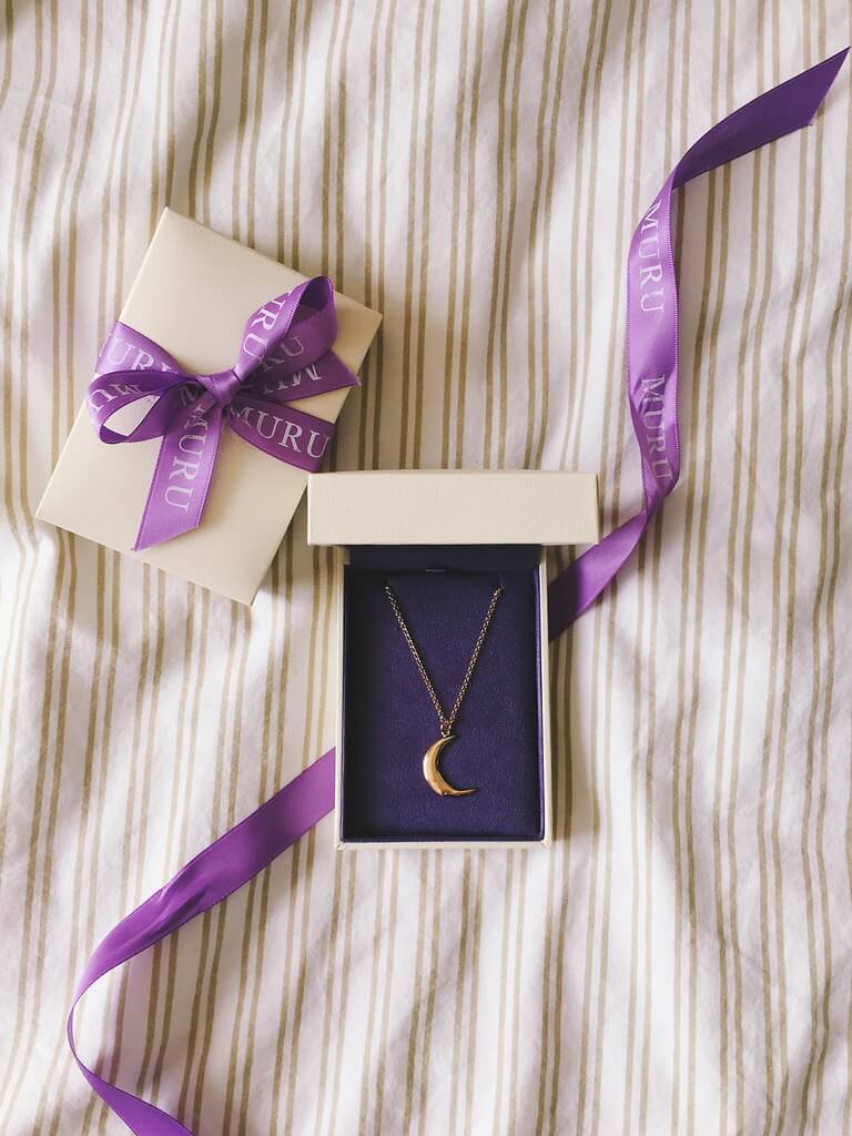 Muru Jewellery moon necklace in box with purple ribbon