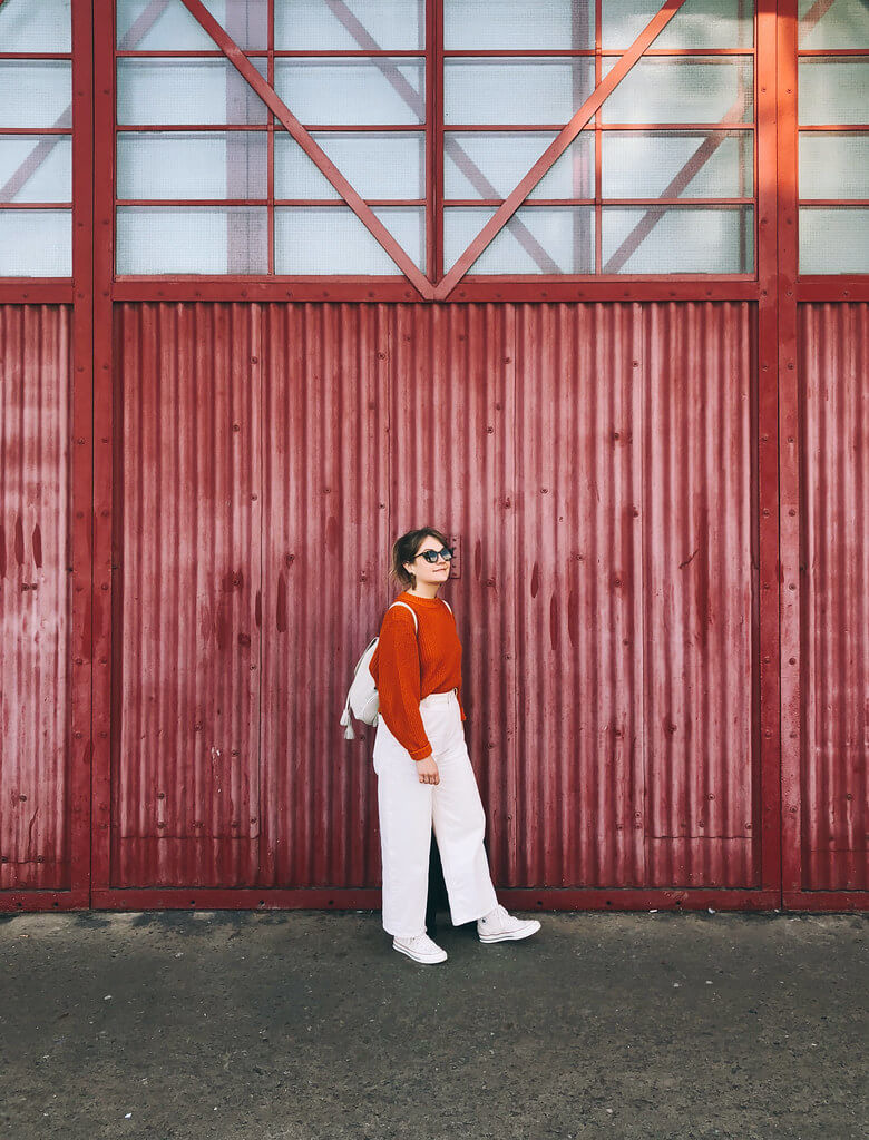 Orange and ivory outfit in front of M Shed Bristol, by Jack Fairey