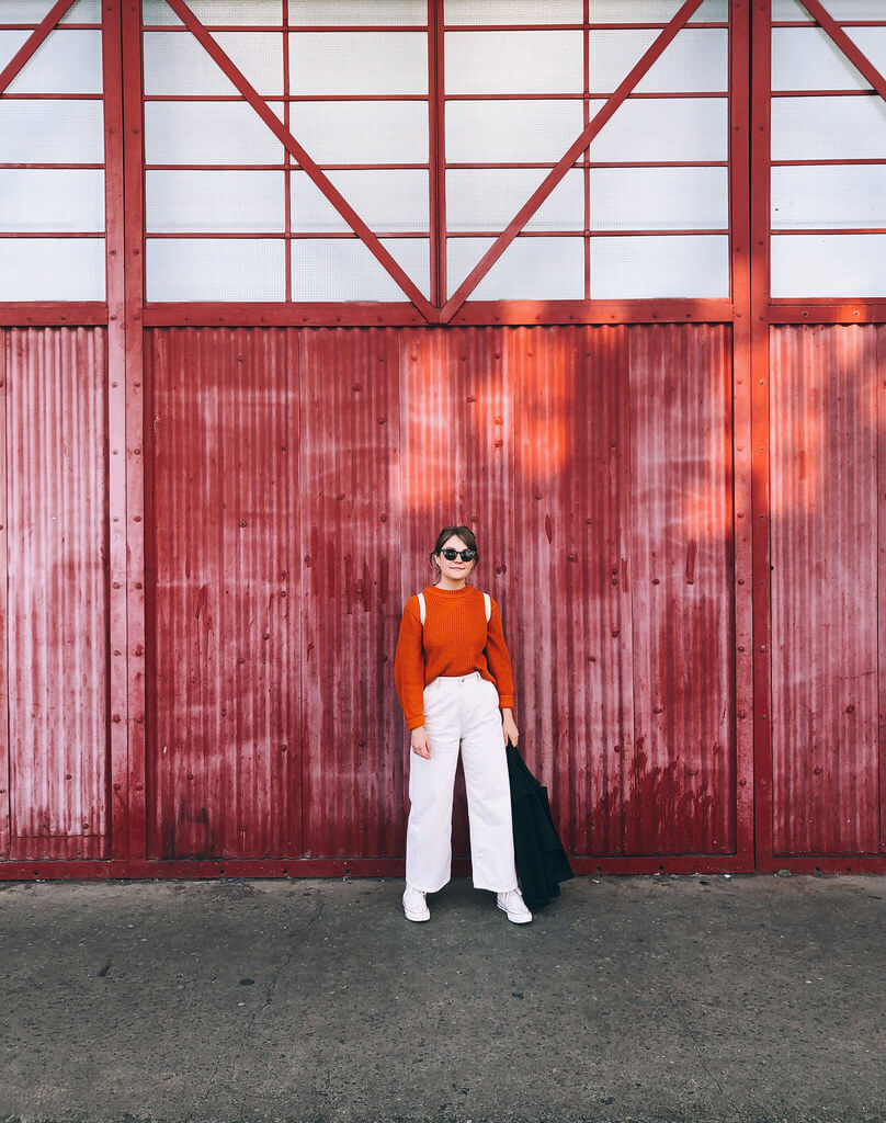 Orange and ivory outfit in front of M Shed Bristol, by Jack Fairey