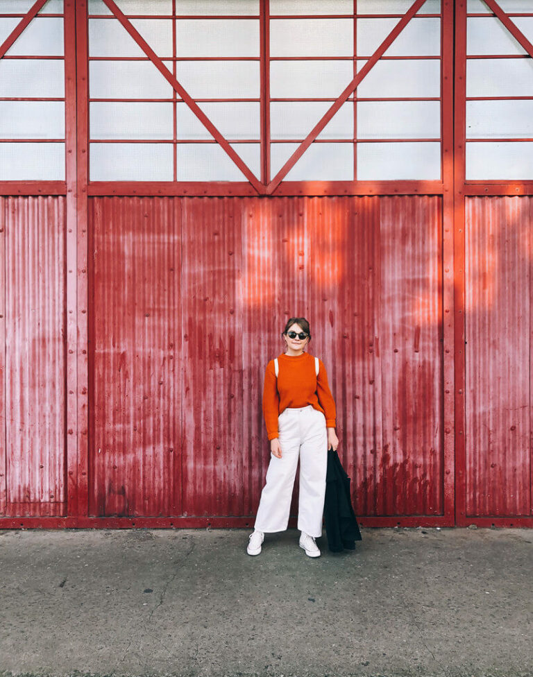 Orange and ivory outfit in front of M Shed Bristol, by Jack Fairey