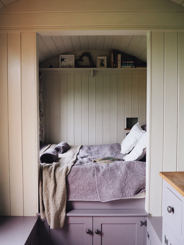 Cosy interior of a shepherd's hut in Dorset, a Plankbridge shepherds hut at colber farm