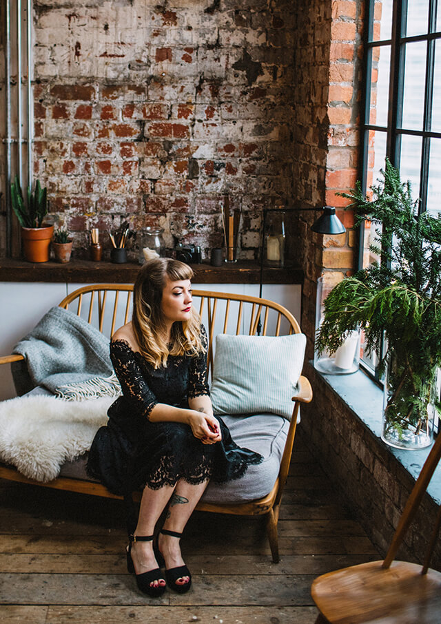 Lyzi Unwin wears vintage style black lace Joanie dress at a Christmas party at The Forge, Bristol