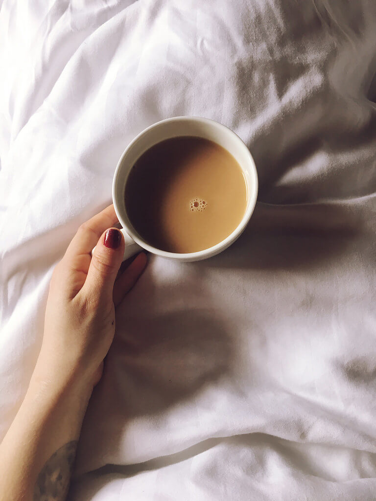 A cup of tea in bed at Log House Holidays