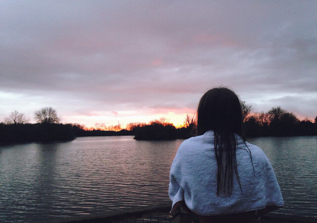 Lyzi watching the sunset across the lake at Log House Holidays