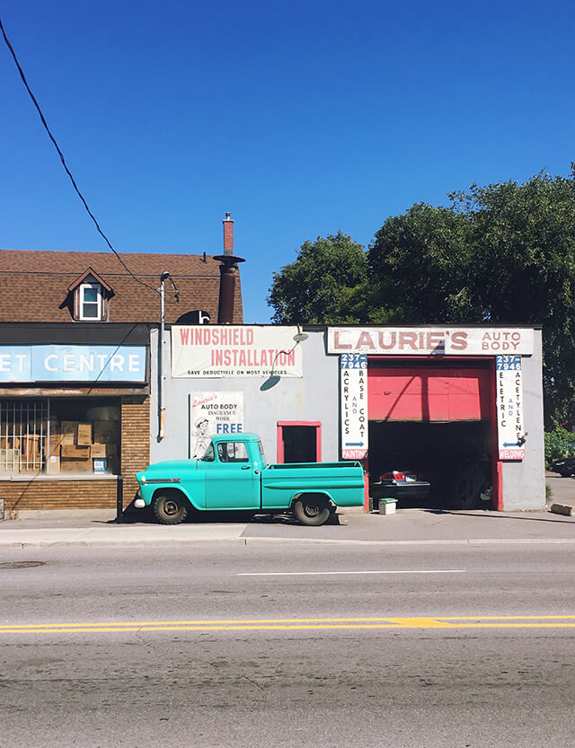 Turquoise vintage truck outside a garage in Ottawa