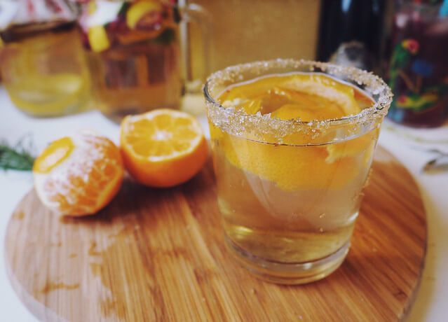 Golden Glitter brandy cocktail with sliced oranges