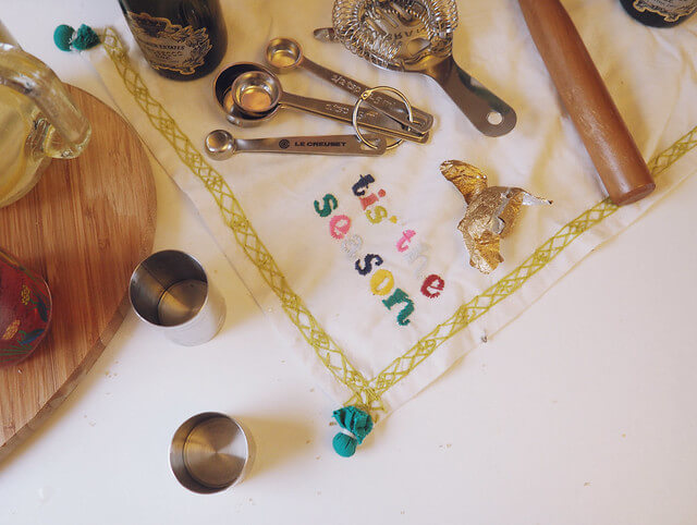 Cocktail making station, with "tis the season" napkin and spirit measurers