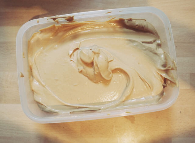 Coffee ice cream mix in a tub