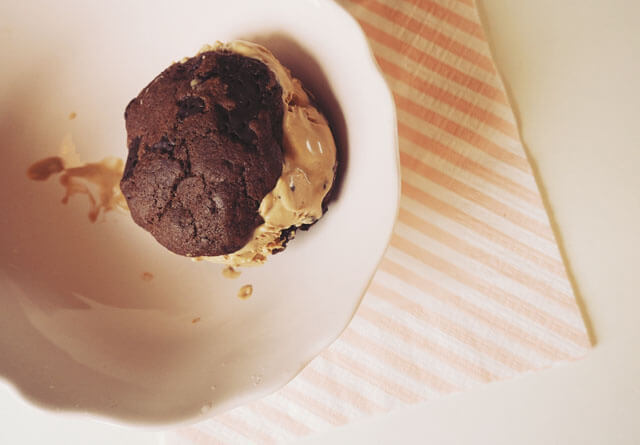 Chocolate chip cookie & coffee ice cream sandwich in a pale pink bowl