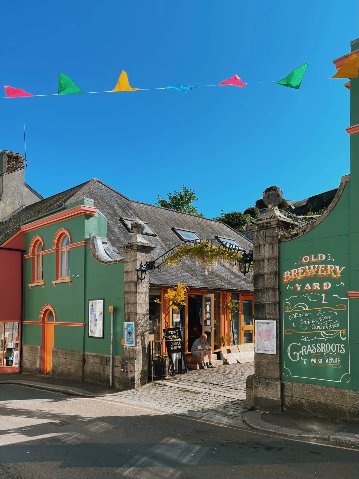 The old brewery yard in Falmouth with flags and blue sky