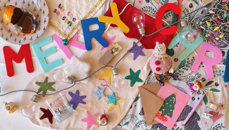 Flatlay of colourful sustainable Christmas decorations and gifts