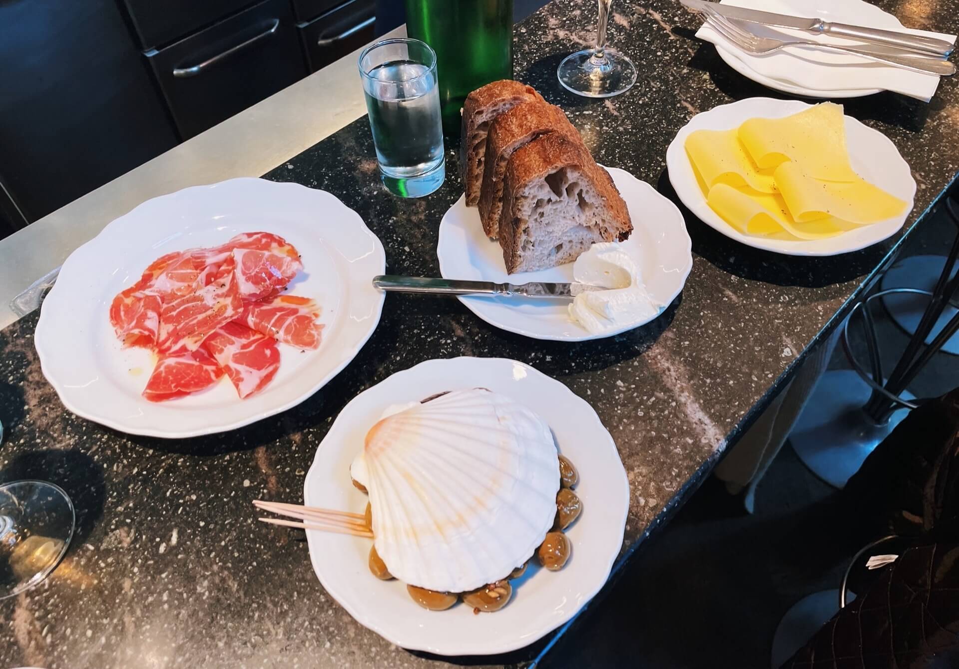 Where to eat girl dinner - Apollo Bar Copenhagen - eating cheese, meat, olives, and bread at the bar. 