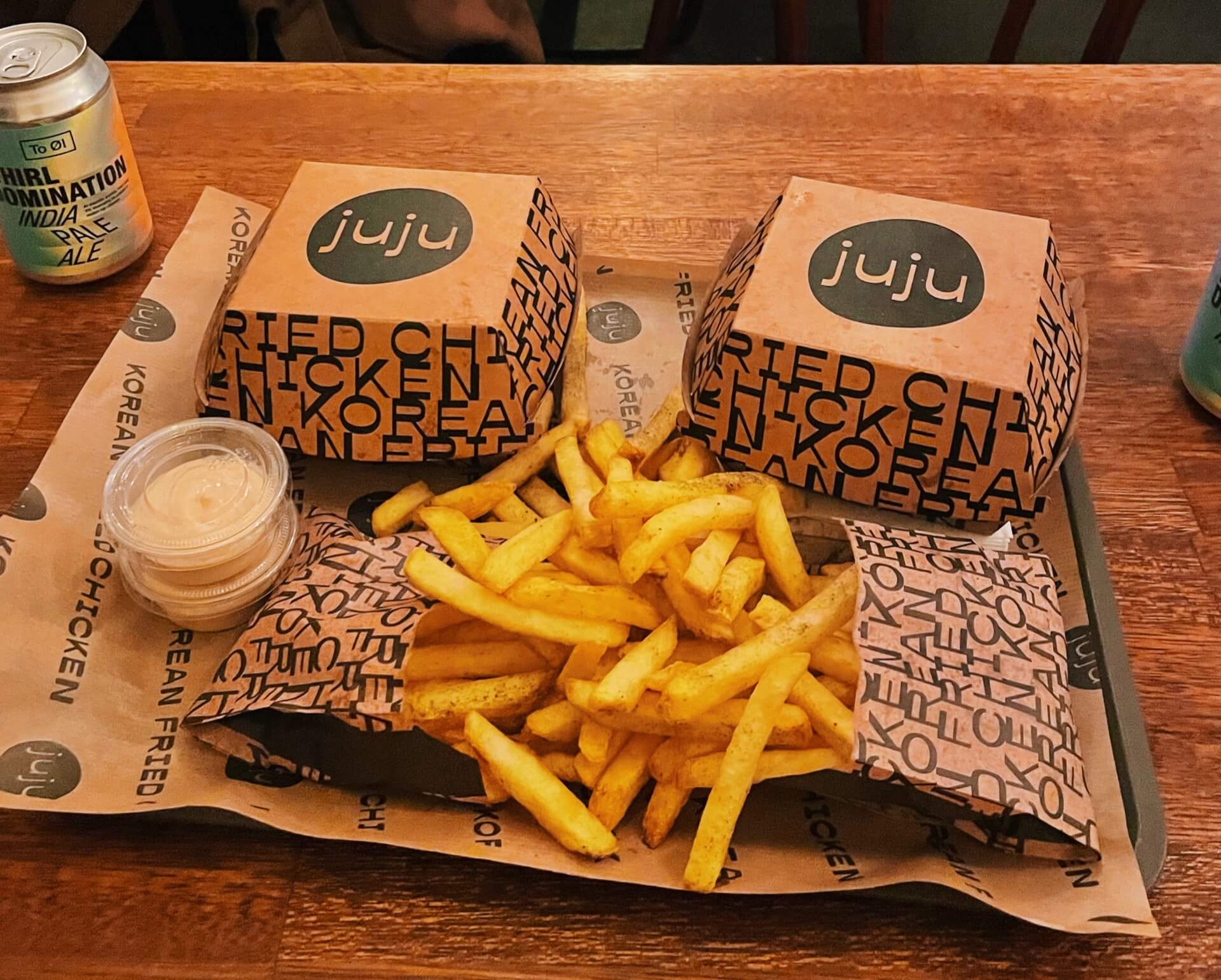 Tray with fries and fried chicken sandwiches in boxes at Juju Copenhagen
